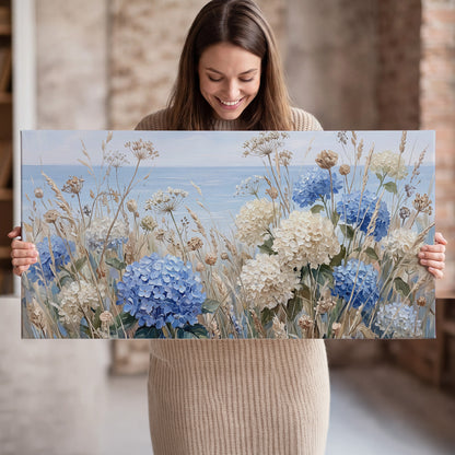 Blue hydrangeas and delicate ivory wildflowers beneath a pale blue sky single canvas wall art held in hands