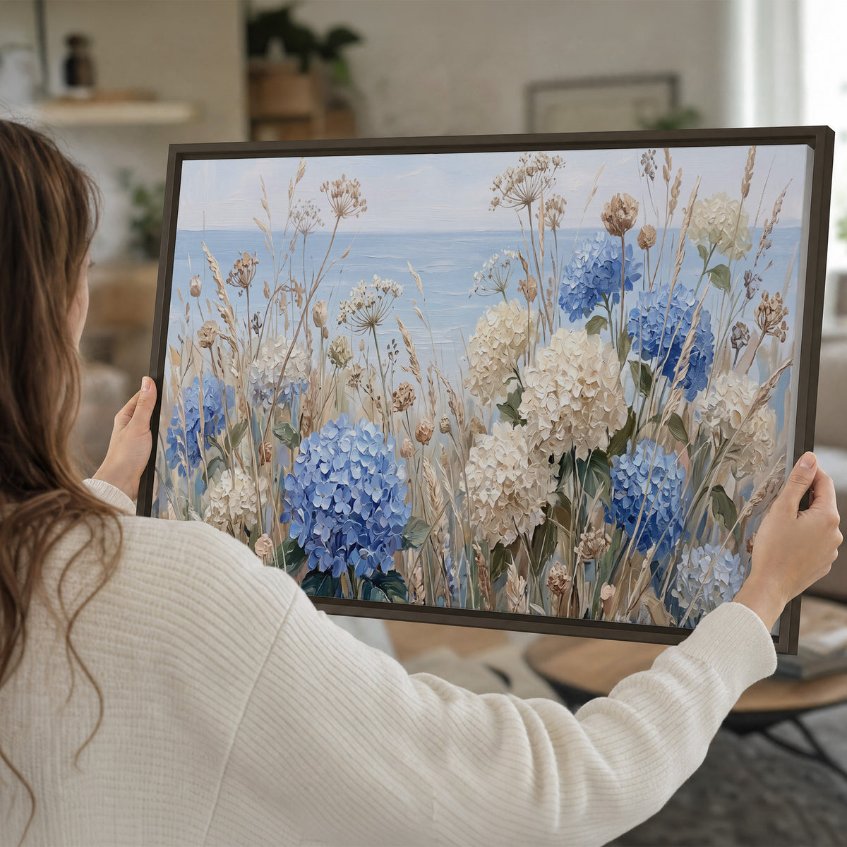 Blue hydrangeas and delicate ivory wildflowers beneath a pale blue sky single framed canvas wall art held in hands