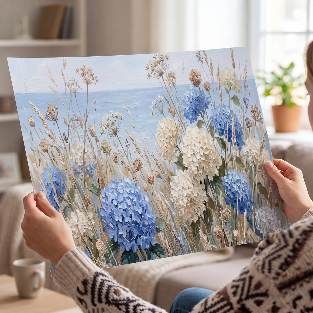 Blue hydrangeas and delicate ivory wildflowers beneath a pale blue sky single poster print held in hands