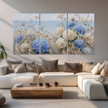 Blue hydrangeas and delicate ivory wildflowers beneath a pale blue sky set of 3 poster prints displayed in a living room