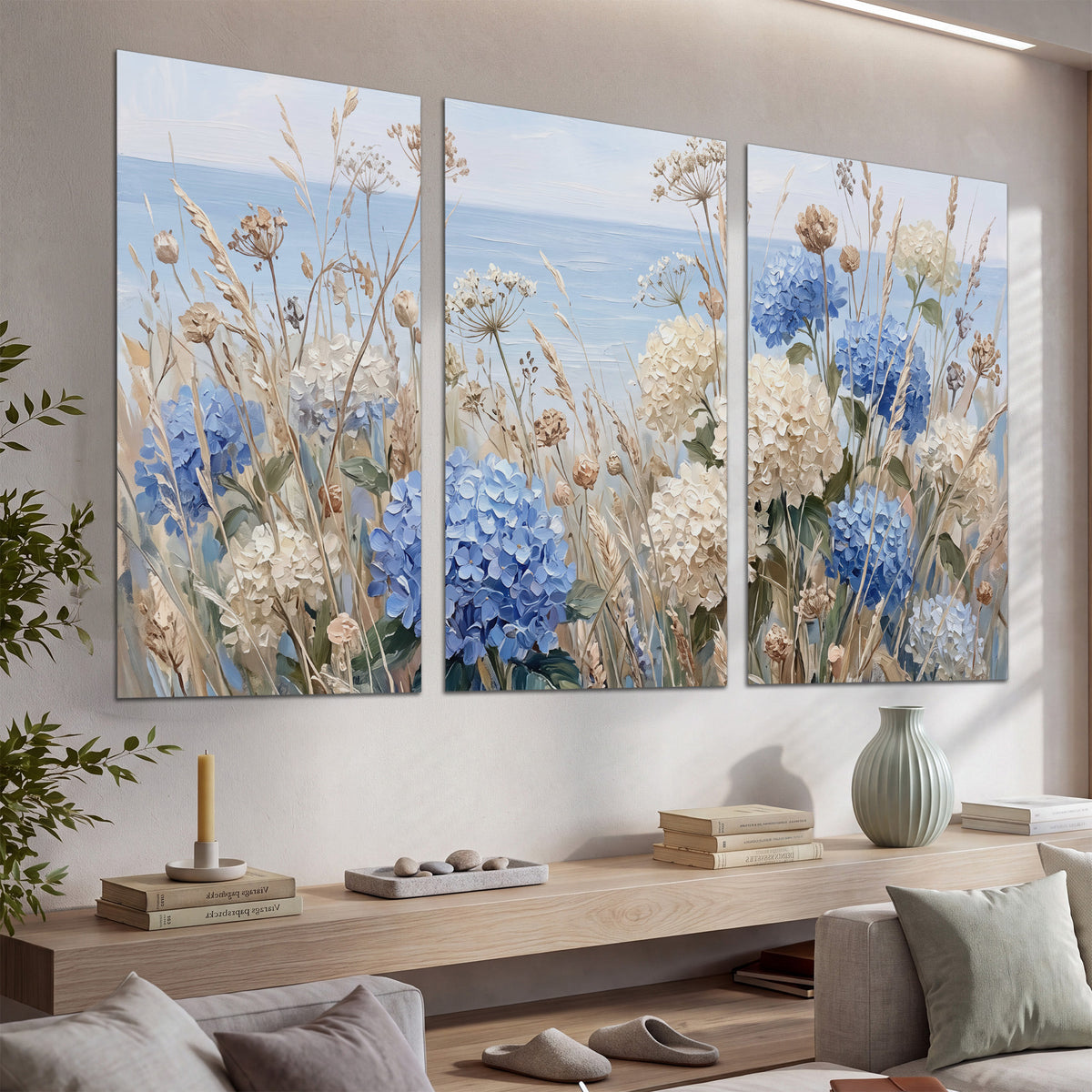 Blue hydrangeas and delicate ivory wildflowers beneath a pale blue sky set of 3 poster prints displayed in a console