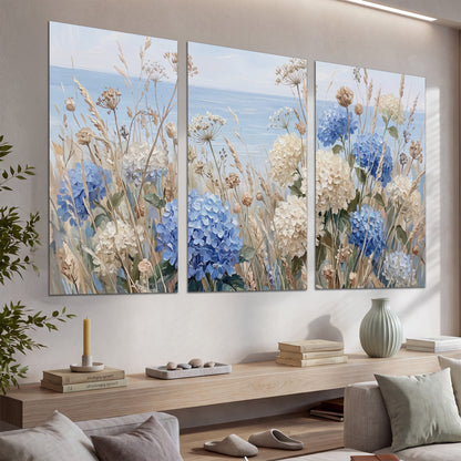 Blue hydrangeas and delicate ivory wildflowers beneath a pale blue sky set of 3 poster prints displayed in a console
