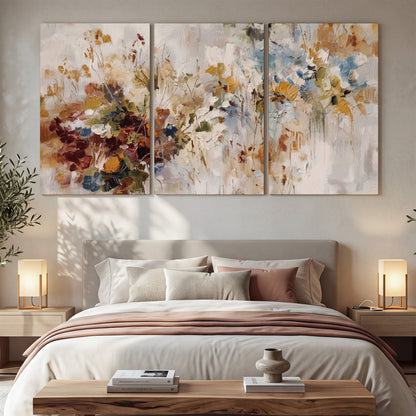 Loose cream, ochre and rust floral shapes with expressive painted-style marks 3 piece canvas wall art displayed in a bedroom
