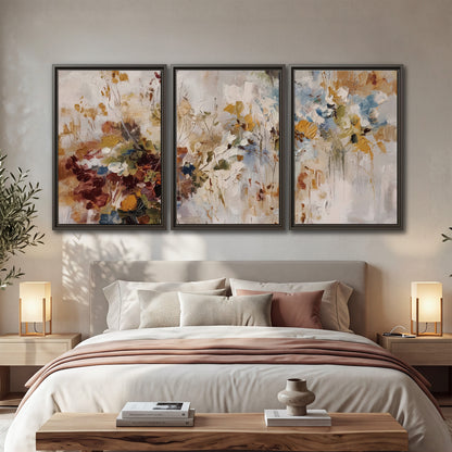 Loose cream, ochre and rust floral shapes with expressive painted-style marks 3 piece framed canvas wall art displayed in a bedroom