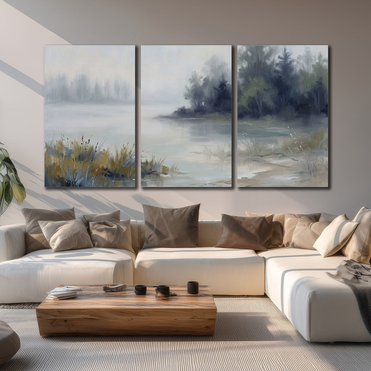 A calm pale lake bordered by dark evergreen trees and distant mist 3 piece canvas wall art displayed in a living room