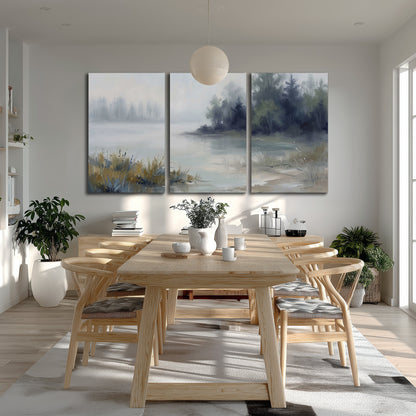 A calm pale lake bordered by dark evergreen trees and distant mist 3 piece canvas wall art room and product view