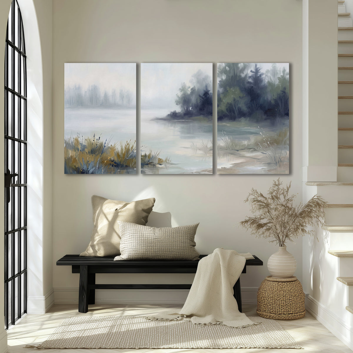A calm pale lake bordered by dark evergreen trees and distant mist 3 piece canvas wall art displayed in a entryway