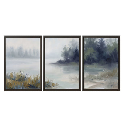 A calm pale lake bordered by dark evergreen trees and distant mist 3 piece framed canvas wall art viewed straight on