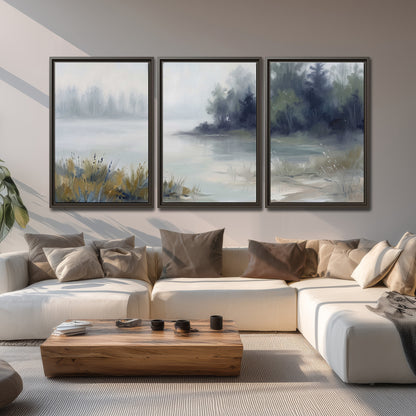 A calm pale lake bordered by dark evergreen trees and distant mist 3 piece framed canvas wall art displayed in a living room