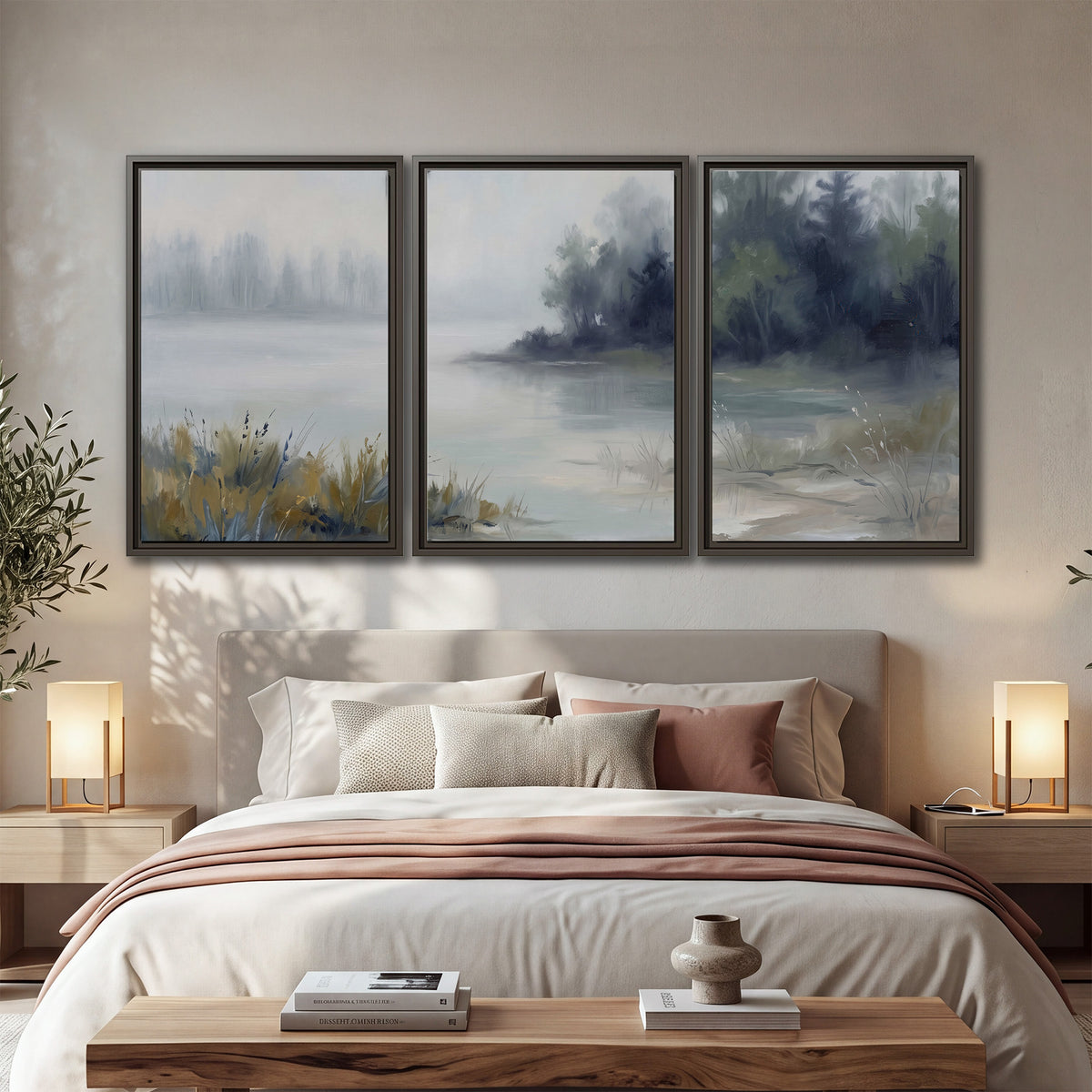 A calm pale lake bordered by dark evergreen trees and distant mist 3 piece framed canvas wall art displayed in a bedroom