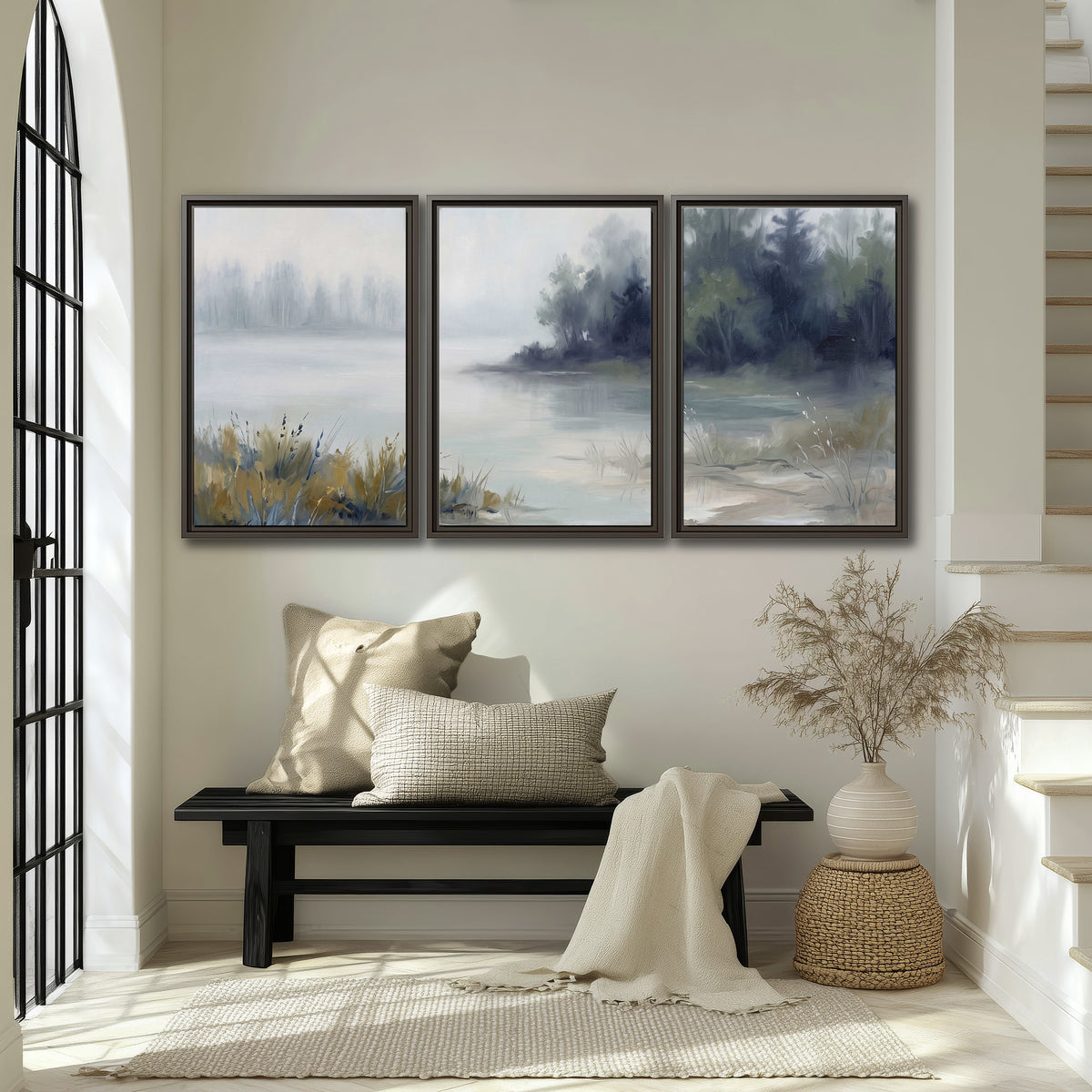 A calm pale lake bordered by dark evergreen trees and distant mist 3 piece framed canvas wall art displayed in a entryway
