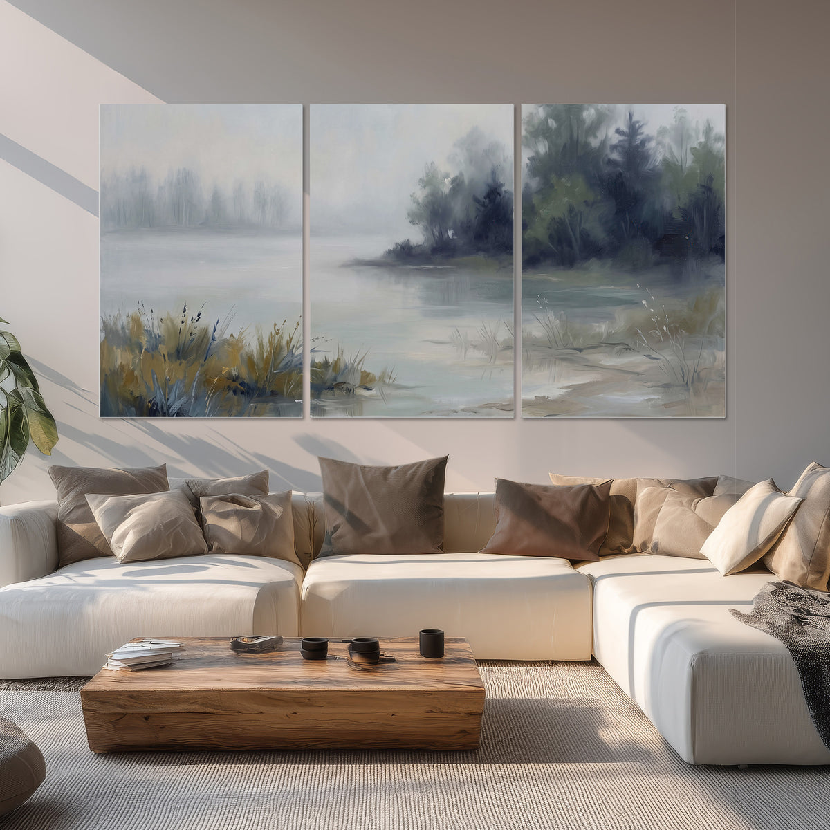 A calm pale lake bordered by dark evergreen trees and distant mist set of 3 poster prints displayed in a living room