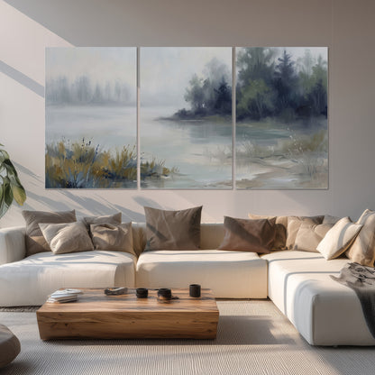 A calm pale lake bordered by dark evergreen trees and distant mist set of 3 poster prints displayed in a living room