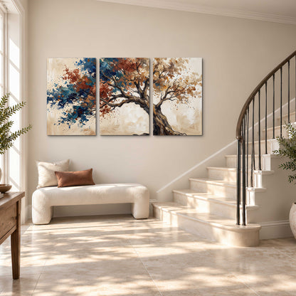A broad tree with rust, blue and ochre foliage against warm cream 3 piece canvas wall art styled in an interior