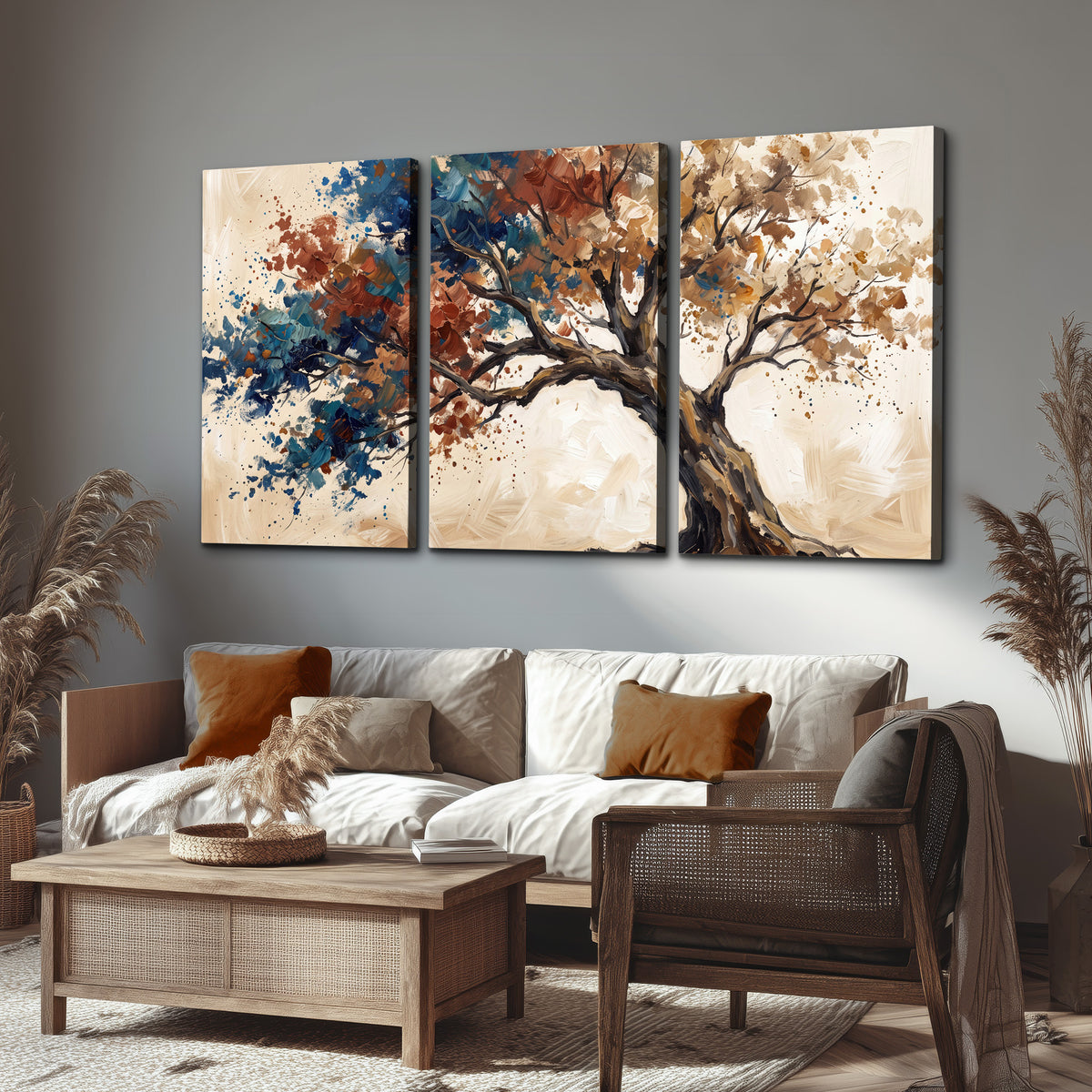 A broad tree with rust, blue and ochre foliage against warm cream 3 piece canvas wall art displayed in a rustic living room