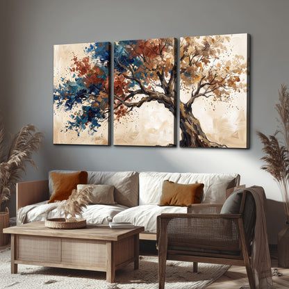 A broad tree with rust, blue and ochre foliage against warm cream 3 piece canvas wall art displayed in a rustic living room