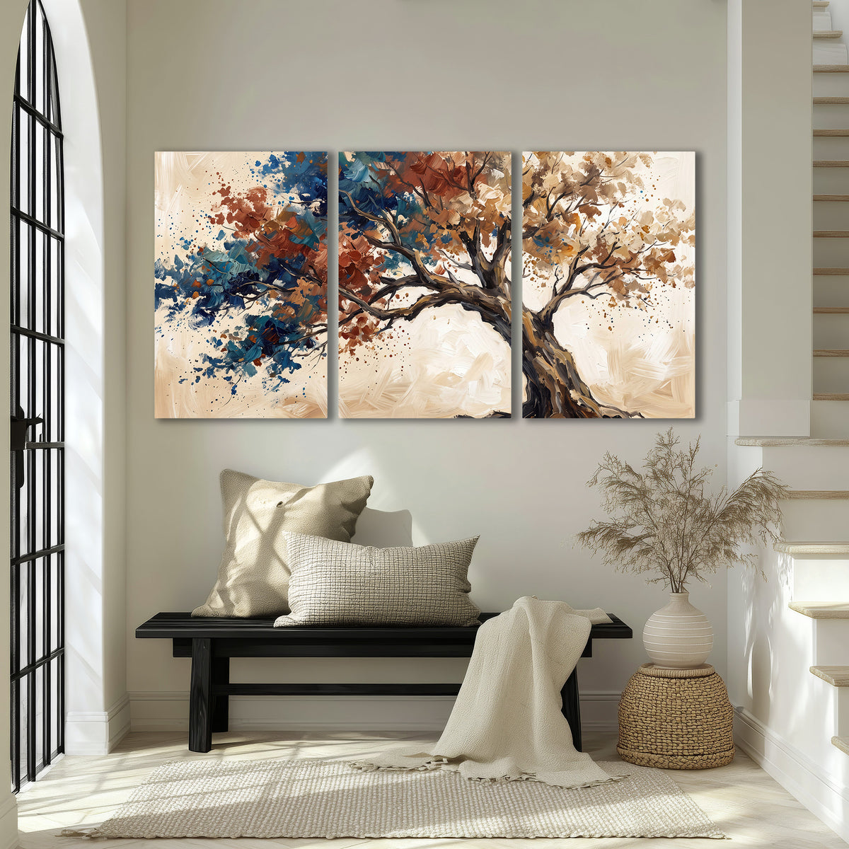 A broad tree with rust, blue and ochre foliage against warm cream 3 piece canvas wall art displayed in a entryway
