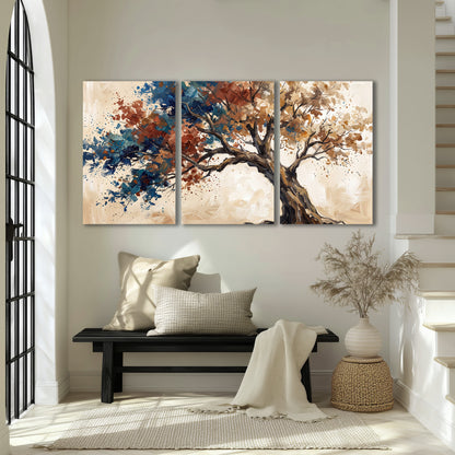 A broad tree with rust, blue and ochre foliage against warm cream 3 piece canvas wall art displayed in a entryway