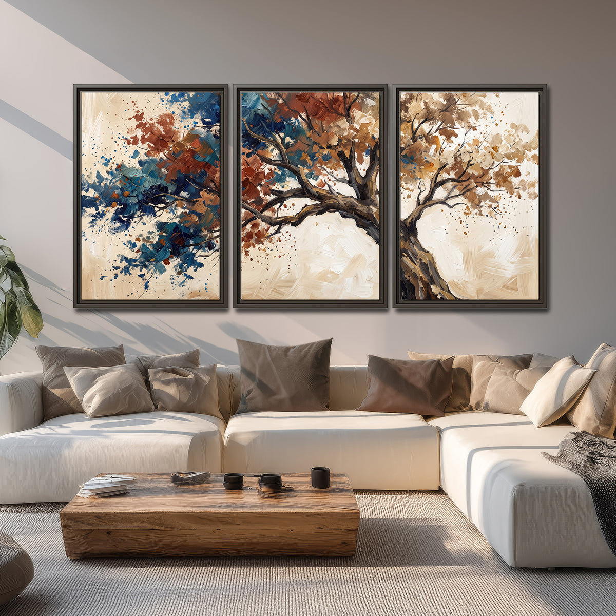 A broad tree with rust, blue and ochre foliage against warm cream 3 piece framed canvas wall art displayed in a living room