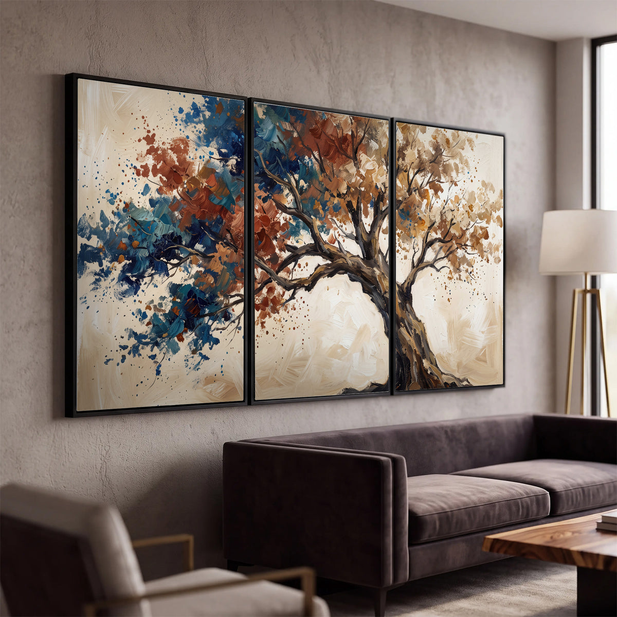 A broad tree with rust, blue and ochre foliage against warm cream 3 piece framed canvas wall art displayed in a modern living room