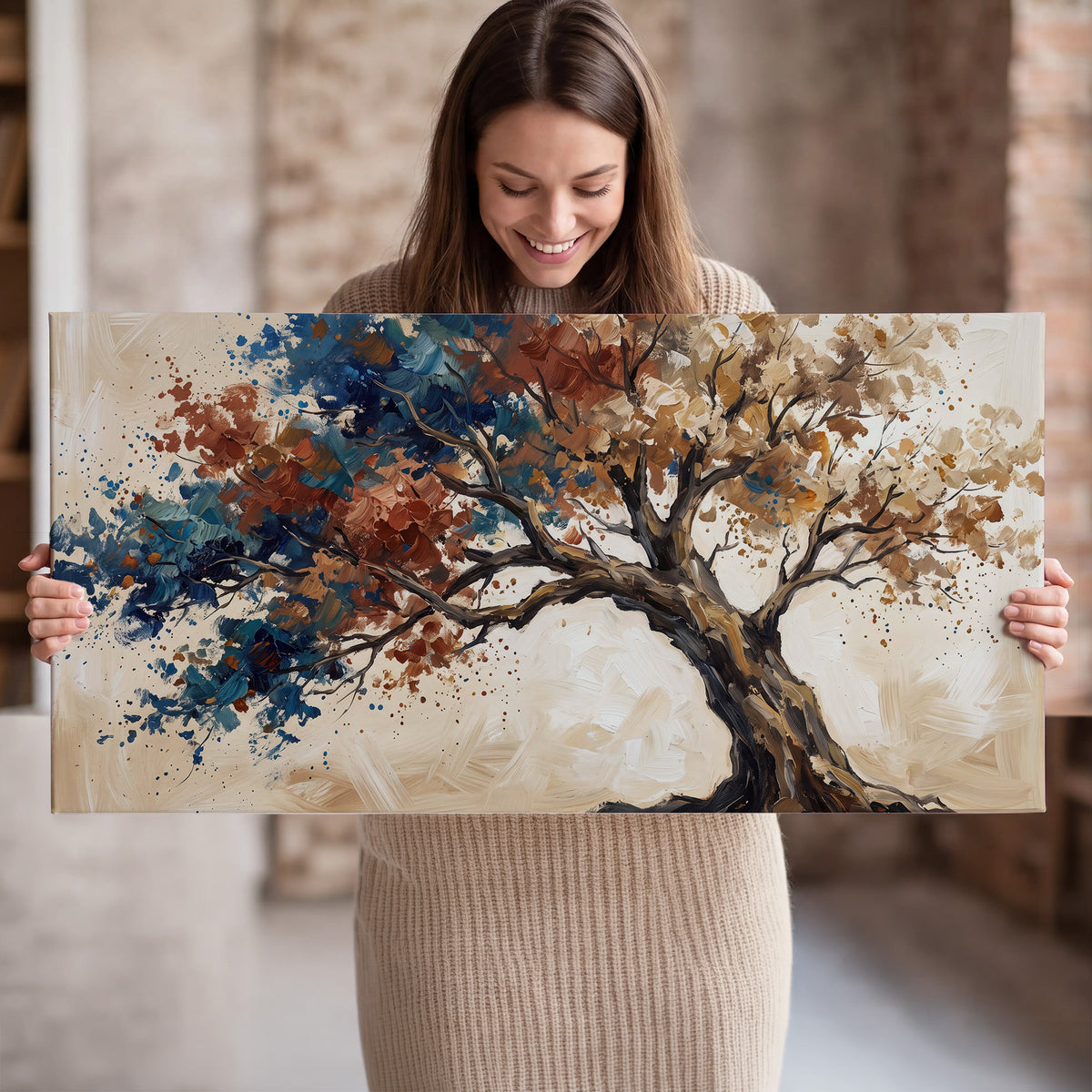 A broad tree with rust, blue and ochre foliage against warm cream single canvas wall art held in hands