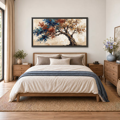 A broad tree with rust, blue and ochre foliage against warm cream single framed canvas wall art styled in an interior