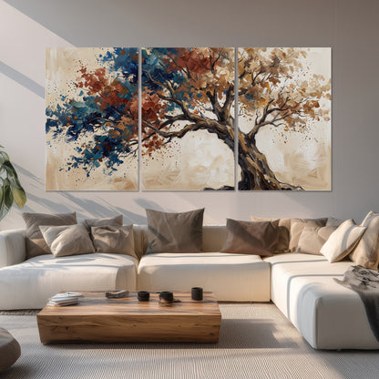 A broad tree with rust, blue and ochre foliage against warm cream set of 3 poster prints displayed in a living room