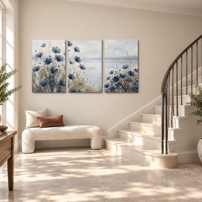 Soft blue flowers and ivory grasses beside a pale coastal horizon 3 piece canvas wall art styled in an interior