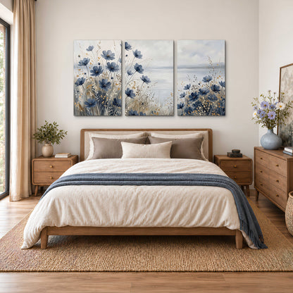 Soft blue flowers and ivory grasses beside a pale coastal horizon 3 piece canvas wall art styled in an interior