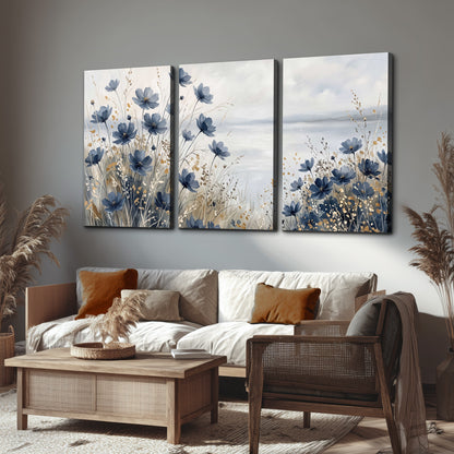 Soft blue flowers and ivory grasses beside a pale coastal horizon 3 piece canvas wall art displayed in a rustic living room