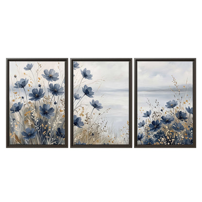 Soft blue flowers and ivory grasses beside a pale coastal horizon 3 piece framed canvas wall art viewed straight on