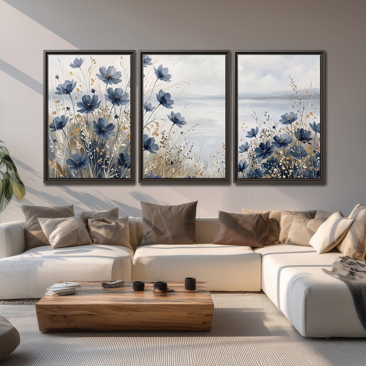Soft blue flowers and ivory grasses beside a pale coastal horizon 3 piece framed canvas wall art displayed in a living room
