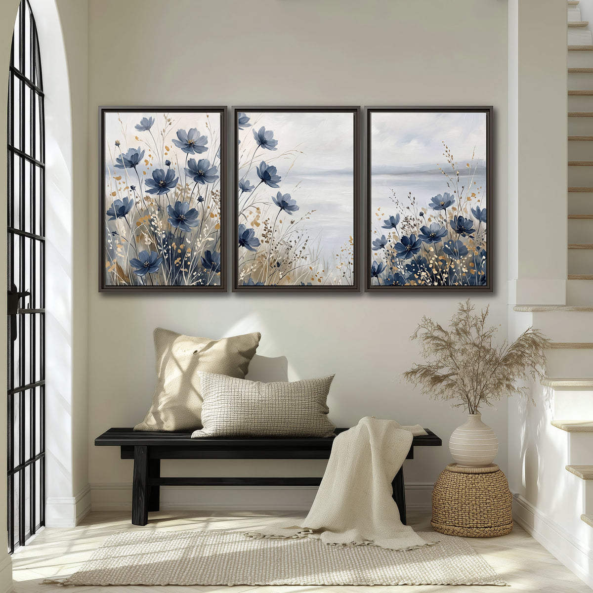 Soft blue flowers and ivory grasses beside a pale coastal horizon 3 piece framed canvas wall art displayed in a entryway