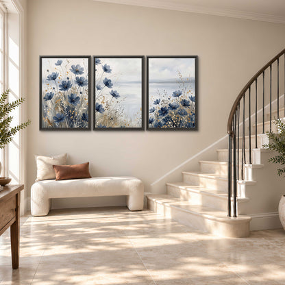 Soft blue flowers and ivory grasses beside a pale coastal horizon 3 piece framed canvas wall art styled in an interior