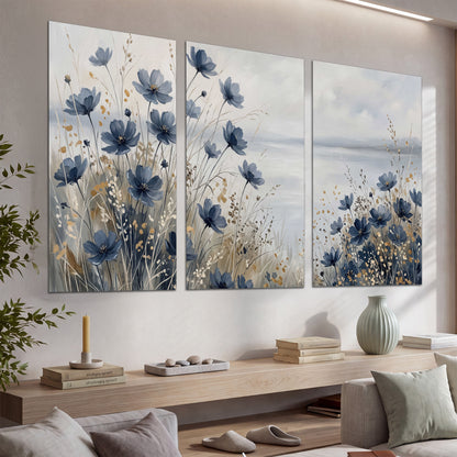 Soft blue flowers and ivory grasses beside a pale coastal horizon set of 3 poster prints displayed in a console