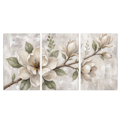 Large ivory magnolia blossoms and soft green leaves on pale gray 3 piece canvas wall art viewed straight on