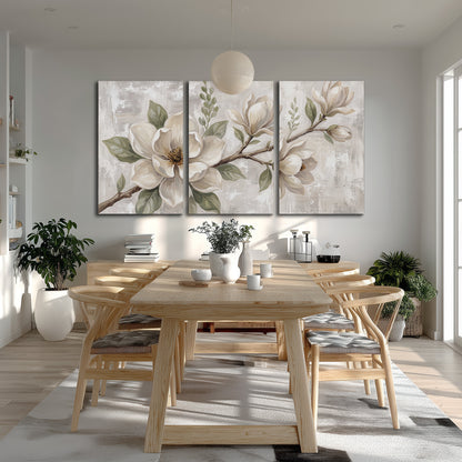Large ivory magnolia blossoms and soft green leaves on pale gray 3 piece canvas wall art room and product view