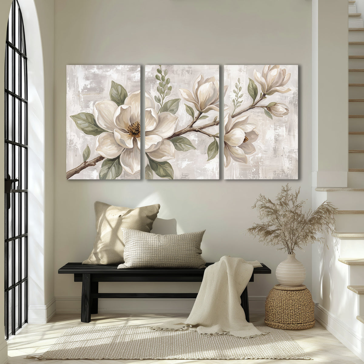 Large ivory magnolia blossoms and soft green leaves on pale gray 3 piece canvas wall art displayed in a entryway