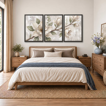 Large ivory magnolia blossoms and soft green leaves on pale gray 3 piece framed canvas wall art styled in an interior