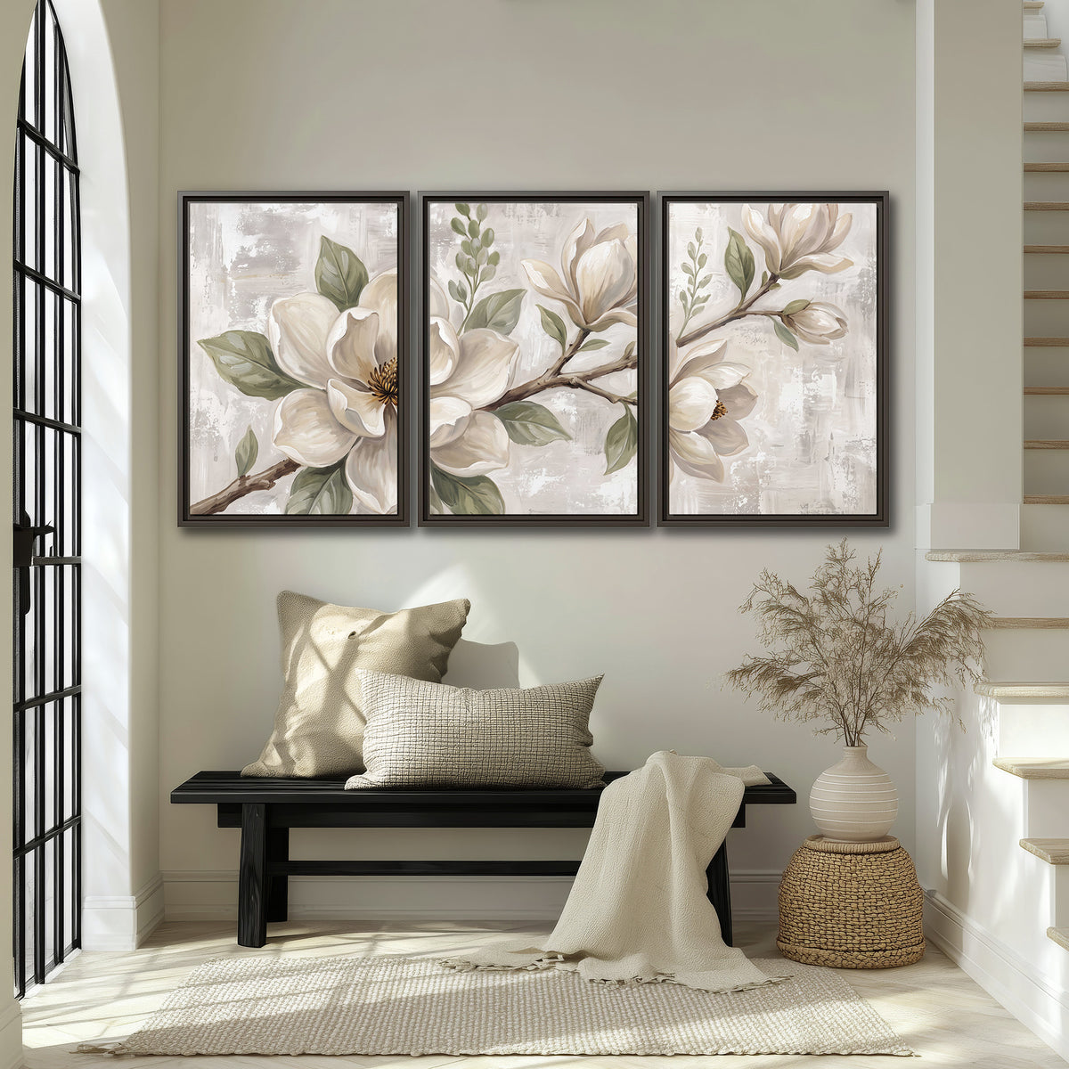 Large ivory magnolia blossoms and soft green leaves on pale gray 3 piece framed canvas wall art displayed in a entryway