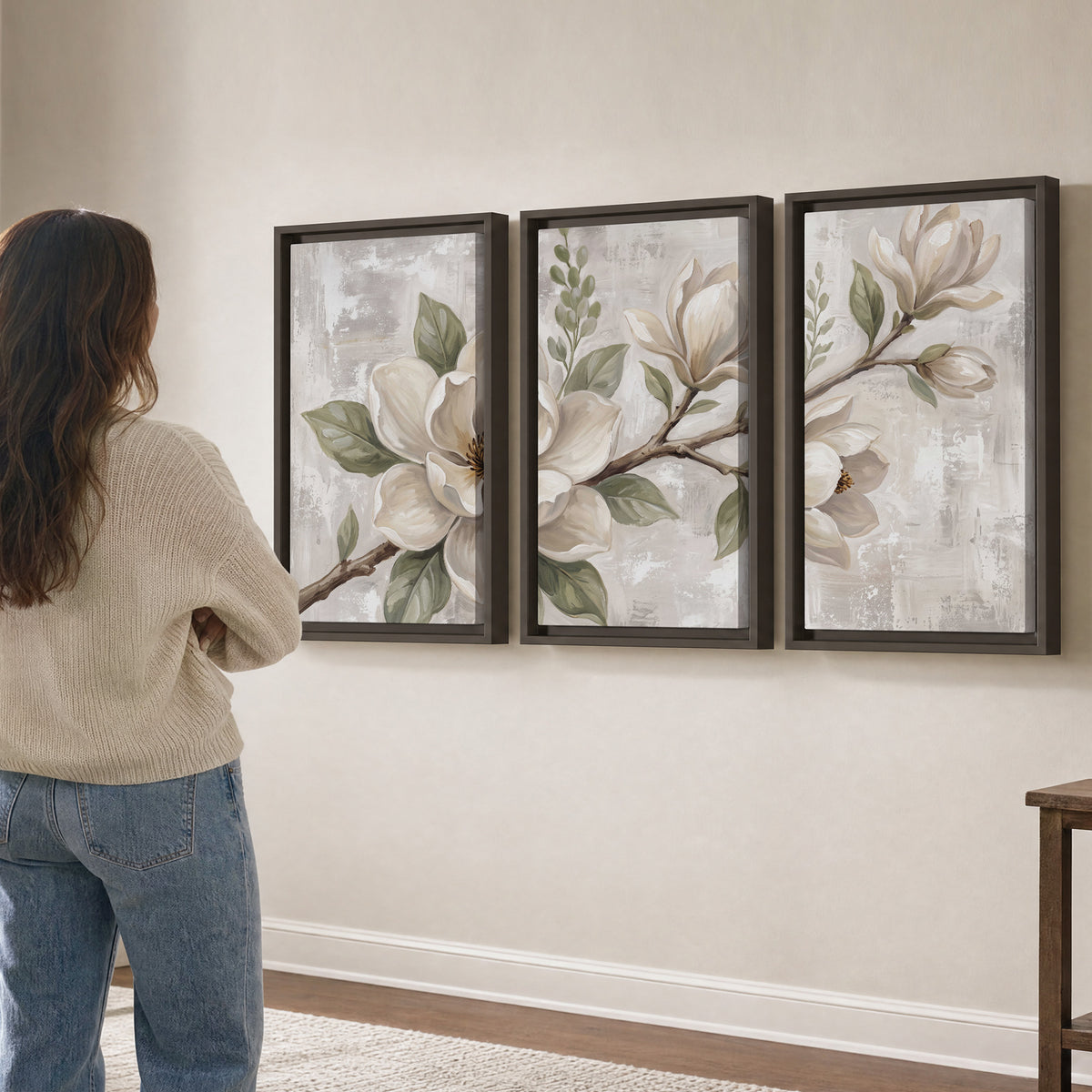Large ivory magnolia blossoms and soft green leaves on pale gray 3 piece framed canvas wall art three panel arrangement on a wall