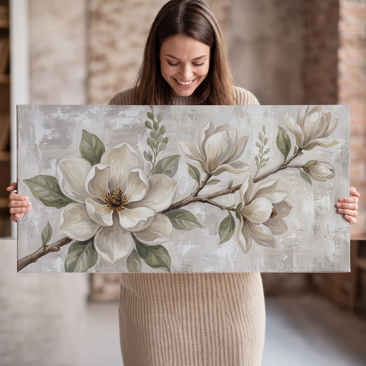 Large ivory magnolia blossoms and soft green leaves on pale gray single canvas wall art held in hands