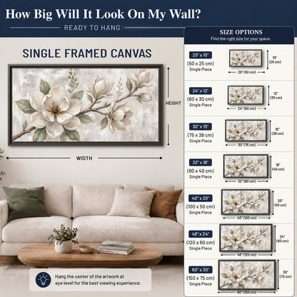 Large ivory magnolia blossoms and soft green leaves on pale gray single framed canvas wall art size guide above a sofa; room view is illustrative