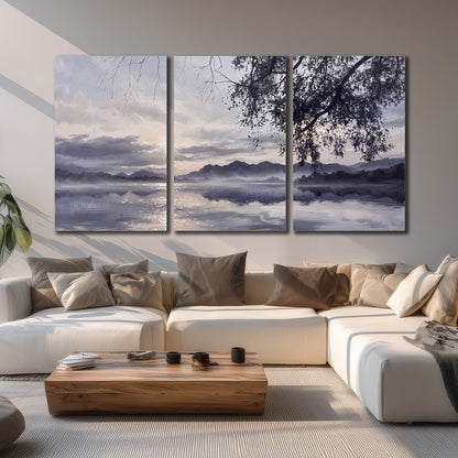 Quiet gray-blue water and dark overhanging branches beneath evening clouds 3 piece canvas wall art displayed in a living room