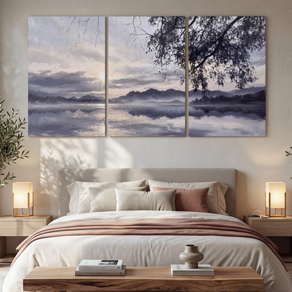 Quiet gray-blue water and dark overhanging branches beneath evening clouds 3 piece canvas wall art displayed in a bedroom
