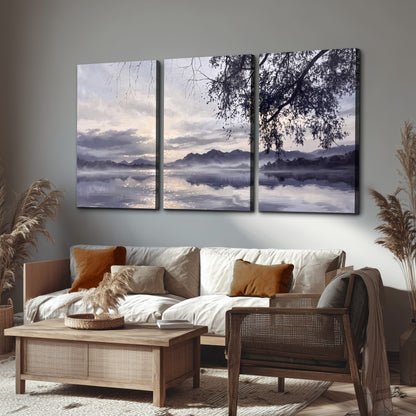 Quiet gray-blue water and dark overhanging branches beneath evening clouds 3 piece canvas wall art displayed in a rustic living room