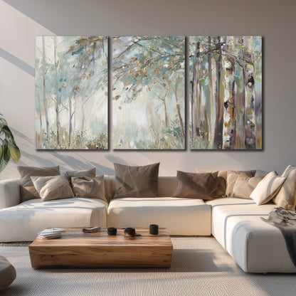 Slender woodland trunks and delicate branches in soft green and cream 3 piece canvas wall art displayed in a living room