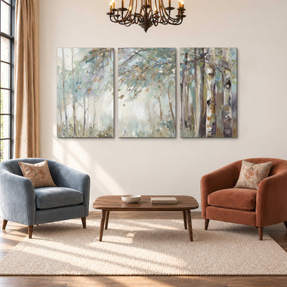 Slender woodland trunks and delicate branches in soft green and cream 3 piece canvas wall art styled in an interior