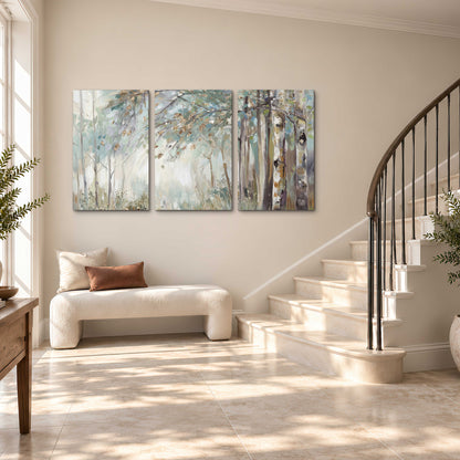 Slender woodland trunks and delicate branches in soft green and cream 3 piece canvas wall art styled in an interior