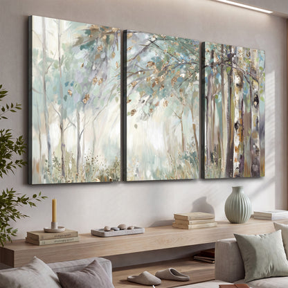 Slender woodland trunks and delicate branches in soft green and cream 3 piece canvas wall art displayed in a console